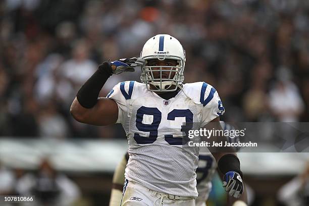 Dwight Freeney of the Indianapolis Colts celebrates after a sack against the Oakland Raiders during an NFL game at Oakland-Alameda County Coliseum on...