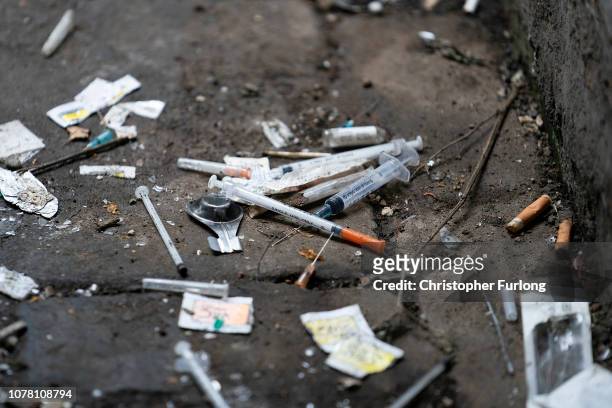 Syringes and paraphernalia used by drug users litter an alley way in Walsall Town Centre on December 06, 2018 in Walsall, England. There were 268,390...