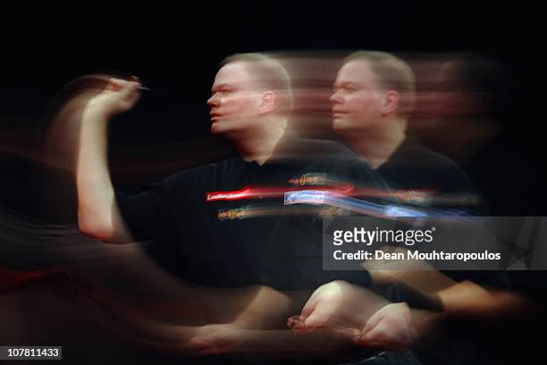 Raymond 'Barney' van Barneveld of Holland in action against Kevin McDine of England during day 11 in the 2011 Ladbrokes.com World Darts Championship...