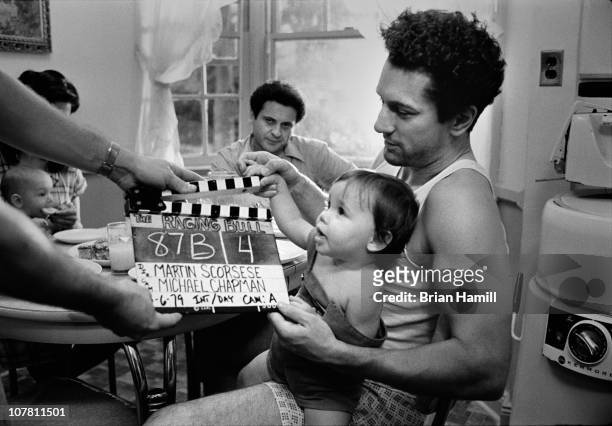 Among others, American actors Robert De Niro , as boxer Jake La Motta, and Joe Pesci , as Joey La Motta, prepare for a scene from the Martin...