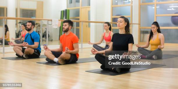 meditating class - yoga studio stock pictures, royalty-free photos & images