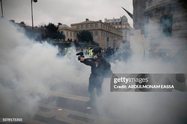 Cameraman films through a cloud of teargas in Paris on January 5 during an anti-government demonstration called by the yellow vest "Gilets Jaunes"...