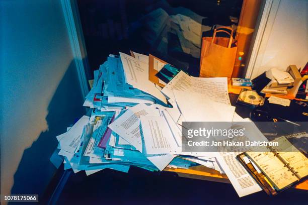 messy office desk piled with paperwork - messy ストックフォトと画像