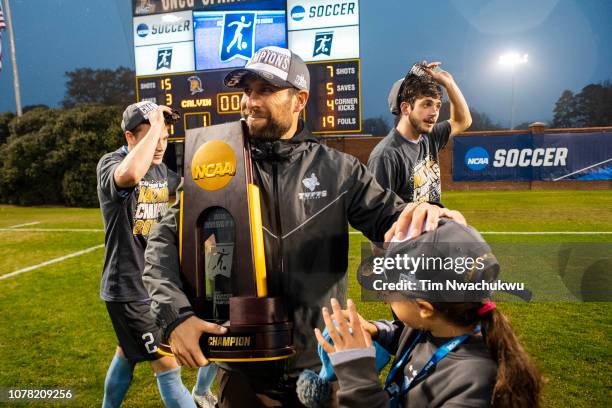 Tufts University head coach Josh Shapiro celebrates with the national championship trophy following the Division III Men's Soccer Championship held...