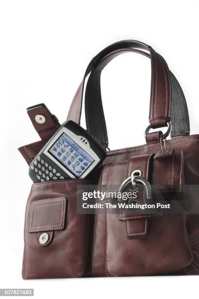 Washington Post Studio DATE: 3/02/06 PHOTO: Julia Ewan/TWP Blackberry with red Coach bag.