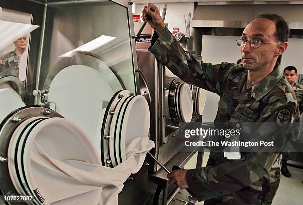 Bill O'Leary USAMRIID opens it's new facilities to the press at Fort Detrick. Pictured, Col George Korch, right, demonstrates a new piece of...