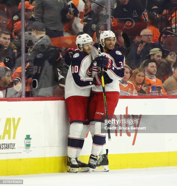 Seth Jones of the Columbus Blue Jackets celebrates his game winning goal at 10 seconds of overtime against the Philadelphia Flyers and is joined by...
