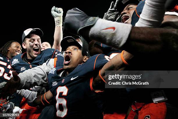 Da'Mon Merkerson of the Syracuse Orange celebrates victory with team mates after defeating the Kansas State Wildcats during the New Era Pinstripe...