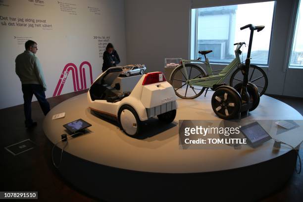Visitors look at items on display at the Museum of Failure exhibition, including a Segway scooter and a plastic bicycle, and a Sinclair C5 electric...