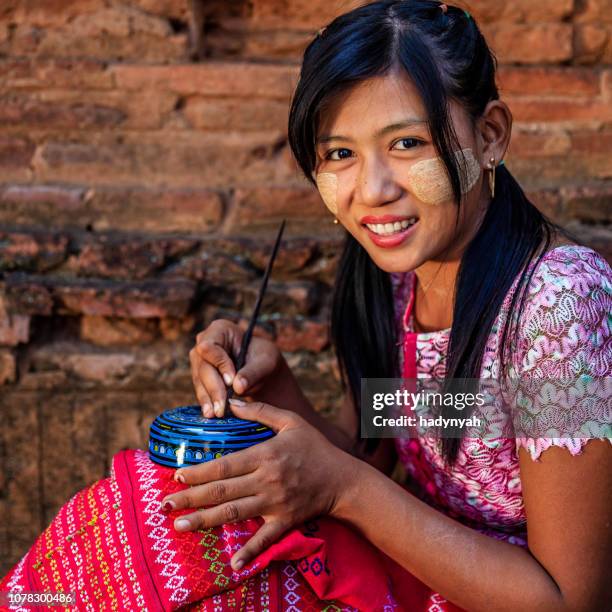 young burmese girl making a lacquerware in bagan, myanmar - burmese people stock pictures, royalty-free photos & images
