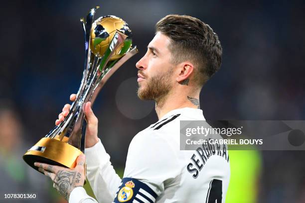 Real Madrid's Spanish defender Sergio Ramos holds the winner's trophy of the 2018 FIFA Club World Cup before the Spanish League football match...