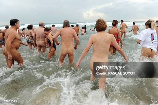 Some of the 300 people take part in a traditional bath ending the year, on December 31, 2010 on the nudist beach of Le Cap d'Agde, southern France....