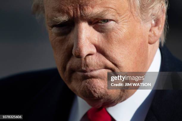 President Donald Trump speaks as he arrives at the White House in Washington, DC, on January 6 after meetings at Camp David. US President Donald...