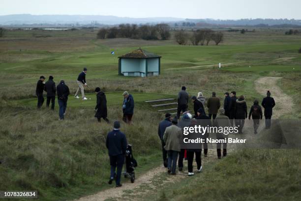 Mark Benka of Lady Margaret Hall, Oxford plays his shot off the 8th tee as crowds look on during his final match against Tom Hawkings of Magdalene,...