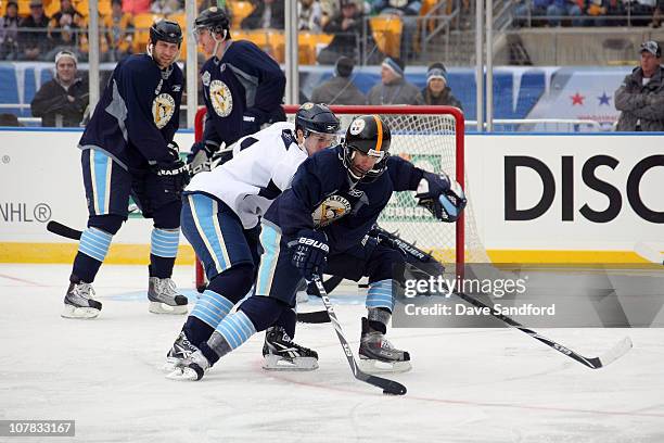 Pascal Dupuis of the Pittsburgh Penguins skates with the puck during practice for the 2011 NHL Bridgestone Winter Classic at Heinz Field on December...