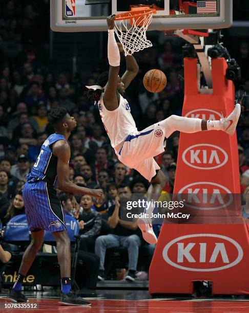 Mo Bamba of the Orlando Magic looks on as Montrezl Harrell of the LA Clippers dunks the ball in the fist half at Staples Center on January 6, 2019 in...