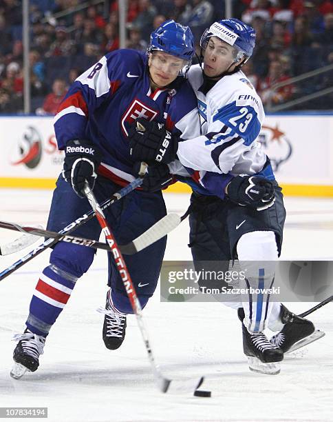 Forward Richard Panik of Slovakia draws a penalty as he tries to get past defenseman Jesse Virtanen of Finland during the 2011 IIHF World U20...