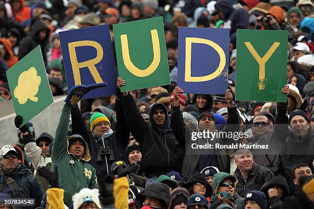 Fans of the Notre Dame Fighting Irish hold up a sign during play against the Miami Hurricanes at Sun Bowl on December 30, 2010 in El Paso, Texas.