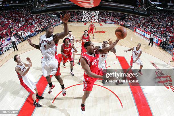 Kyle Lowry of the Houston Rockets shoots the ball over Joey Dorsey of the Toronto Raptors on December 31, 2010 at the Toyota Center in Houston,...