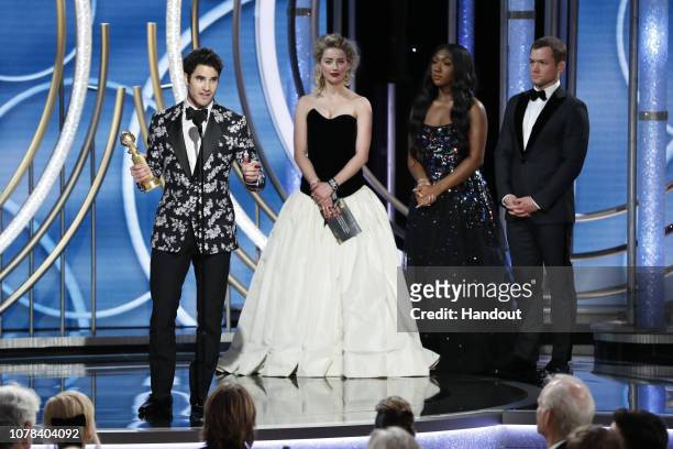 In this handout photo provided by NBCUniversal, Darren Criss from “The Assassination of Gianni Versace: American Crime Story” accepts the Best...