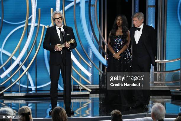 In this handout photo provided by NBCUniversal, Alfonso Cuaron of “Roma” accepts the Best Director – Motion Picture award onstage during the 76th...