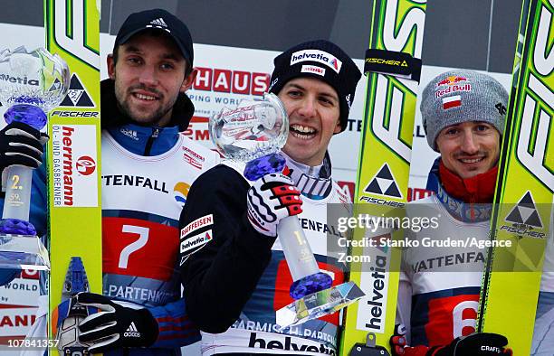 Pavel Karelin of Russia takes 2nd place, Simon Ammann of Switzerland takes 1st place,Adam Malysz of Poland takes 3rd during during the FIS Ski...