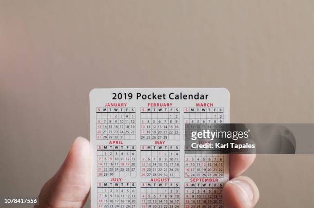 holding a pocket new year calendar - new year new you 2019 stock pictures, royalty-free photos & images