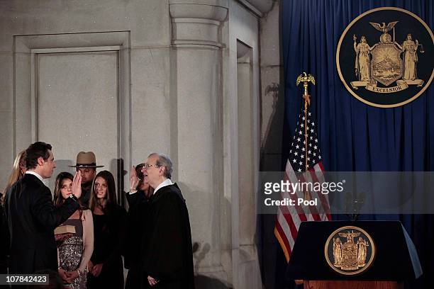 Andrew M. Cuomo is sworn in as Governor of New York at his inauguration in the War Room at the state Capitol in Albany by Chief Judge of the Court of...