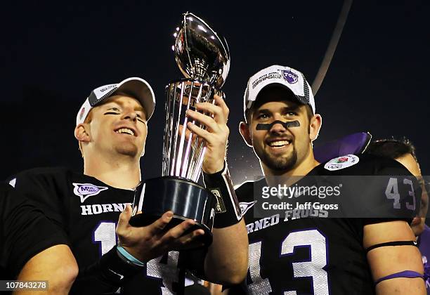Quarterback Andy Dalton and linebacker Tank Carder of the TCU Horned Frogs hold the Rose Bowl Championship Trophy after defeating the Wisconsin...