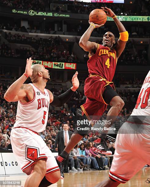 Antawn Jamison of the Cleveland Cavaliers shoots against Carlos Boozer of the Chicago Bulls during the game on January 1, 2011 at the United Center...