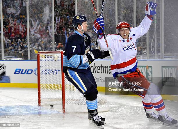 Eric Fehr of the Washington Capitals celebrates scoring in third period as Paul Martin of the Pittsburgh Penguins looks on during the 2011 NHL...