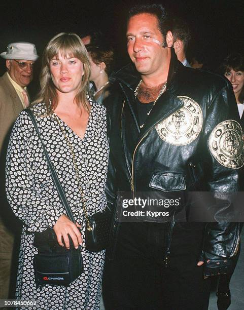 American stand-up comedian, actor, musician, and producer Andrew Dice Clay with his wife Kathleen 'Trini' Monica at a red carpet event, circa 1995.