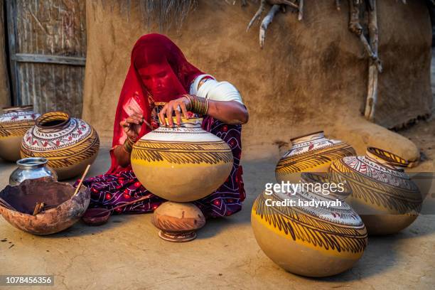 indian woman painting vases in her workshop, rajasthan, india - craft stock pictures, royalty-free photos & images