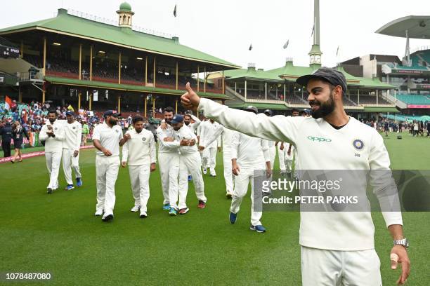 India's captain Virat Kohli gestures as his team celebrates their series win on the fifth day of the fourth and final cricket Test against Australia...