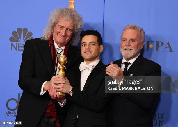 Best Actor in a Motion Picture Drama for "Bohemian Rhapsody" winner Rami Malek poses with Queen band members Roger Taylor and Brian May during the...