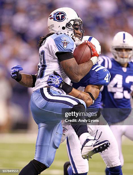 Chris Johnson of the Tennessee Titans is tackled by Antoine Bethea of the Indianapolis Colts at Lucas Oil Stadium on January 2, 2011 in Indianapolis,...