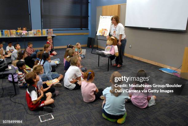 Kim Brown ,sister of author Marc Brown, stands behind the character D.W. While talking to children at the Mamie Doud Eisenhower Public Library on...