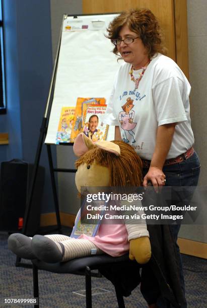 Kim Brown ,sister of author Marc Brown, stands behind the character D.W. While talking to children at the Mamie Doud Eisenhower Public Library on...