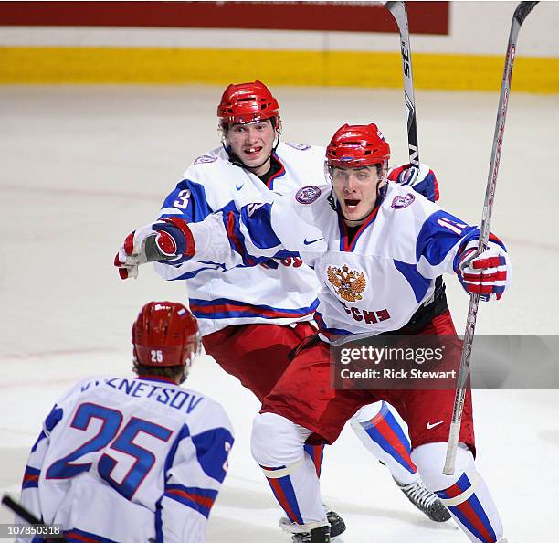 Maxim Kitsyn of Russia celebrates his game tying goal against Finland with teammates Yevgeni Kuznetsov and Nikita Pivtsakin during the 2011 IIHF...