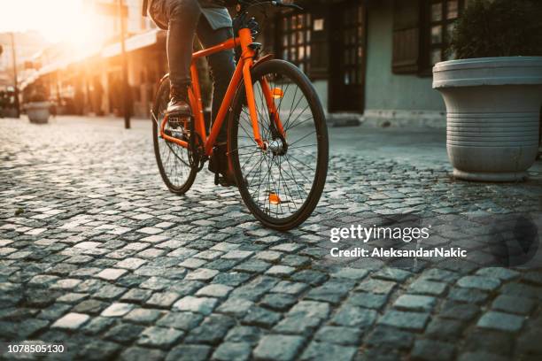 on the way to work by bicycle - cobblestone transport stock pictures, royalty-free photos & images