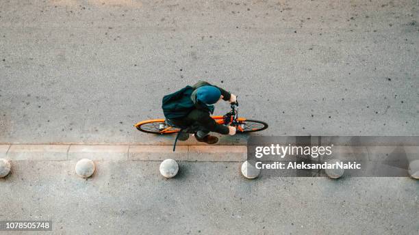 urban cyclist on the street - commuter cycling stock pictures, royalty-free photos & images