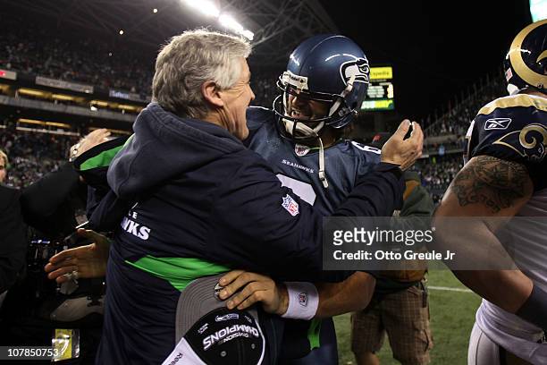 Head coach Pete Carroll of the Seattle Seahawks hugs quarterback Charlie Whitehurst after defeating the St. Louis Rams 16-6 at Qwest Field on January...