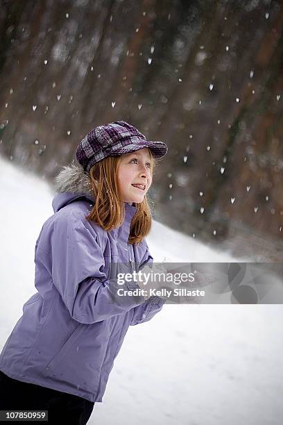 a young girl catching snowflakes - catching snowflakes stock pictures, royalty-free photos & images