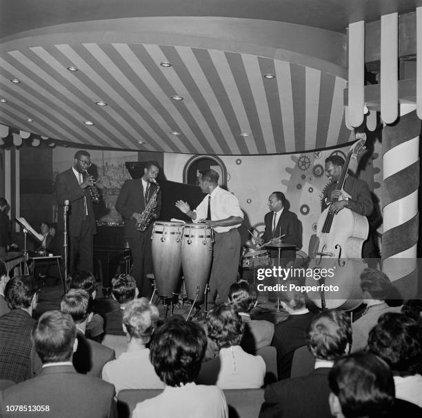 Jamaican jazz saxophone player Joe Harriott pictured 2nd from left with trumpet player Shake Keane , on left, and his band performing live on stage...