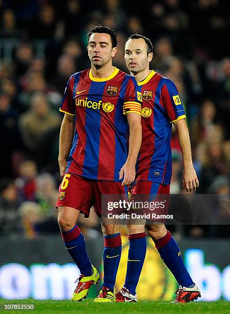 Xavi Hernandez of Barcelona and his teammate Andres Iniesta follow the game during the La Liga match between Barcelona and Levante UD at Camp Nou on...