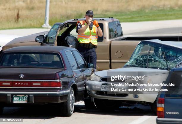 Broomfield Police Sgt. Rick Kempsell, center, takes photos of a 4 car accident at Hwy. 287 and W. Miramonte Blvd. On Thursday. West Miramonte was...