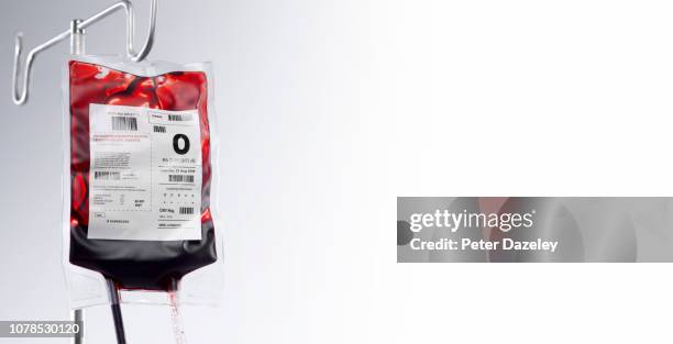 blood bag on hospital stand with copy space - infuus stockfoto's en -beelden