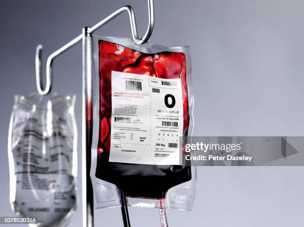 blood bag and saline drip on hospital stand - saline drip stock pictures, royalty-free photos & images