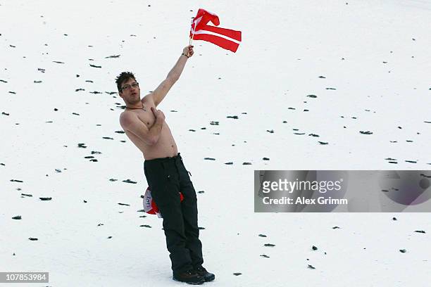 Supporter of Austria sings the national anthem after Thomas Morgenstern of Austria won the FIS Ski Jumping World Cup event of the 59th Four Hills ski...