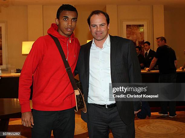 New player Luiz Gustavo and manager Christian Nerlinger arrive at the Hotel Grand Hyatt during the FC Bayern Muenchen training camp on January 3,...